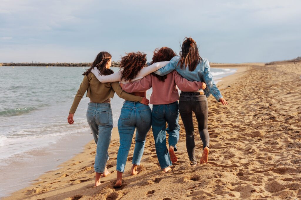 rare,view,of,a,four,young,women,walking,together,barefoot